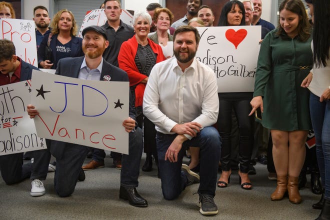 US Republican Senate candidate for Ohio J.D. Vance poses for a group photo with supporters at a campaign office on Oct. 13, 2022, in Canton, Ohio. According to a new Emerson College/The Hill Survey, Vance is locked in a dead heat with Democratic Representative Tim Ryan in this year's closely watched Ohio Senate race.