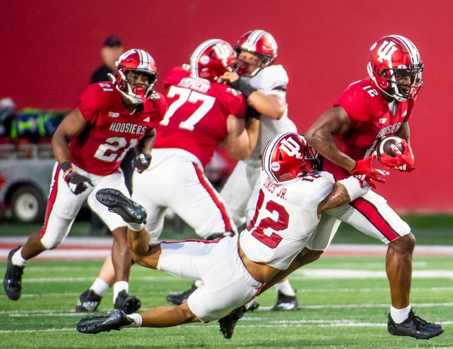 Indiana's Miles Cross (12) battles against Indiana's Terry Jones Jr. (12) during the Indiana football spring game at Memorial Stadaium on Thursday, April 18, 2024.