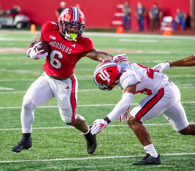 Indiana's Justice Ellison (6) fights off Indiana's Lincoln Murph (45) during the Indiana football spring game at Memorial Stadaium on Thursday, April 18, 2024.