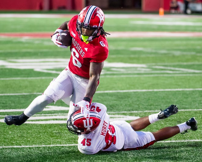 Indiana's Justice Ellison (6) fights off Indiana's Lincoln Murph (45) during the Indiana football spring game at Memorial Stadaium on Thursday, April 18, 2024.