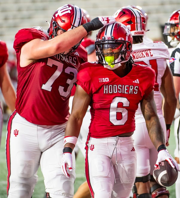 Indiana's Justice Ellison (6) gets a pat on the head from Austin Barrett (73) after scoring a touchdwon during the Indiana football spring game at Memorial Stadaium on Thursday, April 18, 2024.