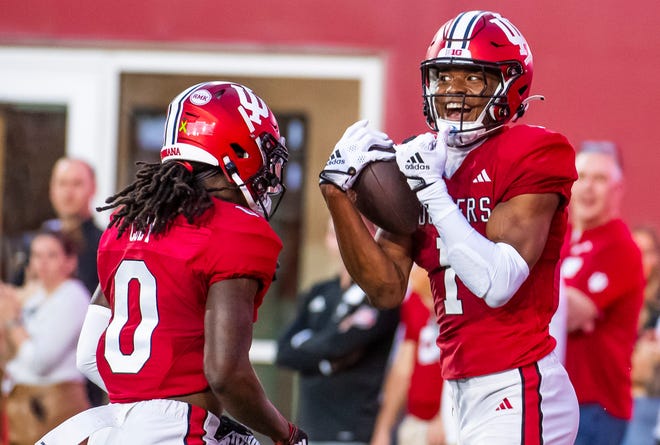 Indiana's Donaven McCulley (1) celebrates his touchdown with Andison Coby (0) during the Indiana football spring game at Memorial Stadaium on Thursday, April 18, 2024.