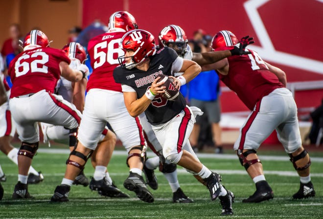 Indiana's Kurtis Rourke (9) scrambles during the Indiana football spring game at Memorial Stadaium on Thursday, April 18, 2024.