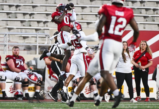 Indiana Hoosiers wide receiver Andison Coby (0) catches a pass over Indiana Hoosiers defensive back Lincoln Murff (45) during the Indiana football spring game at Memorial Stadium on Thursday, April 18, 2024.