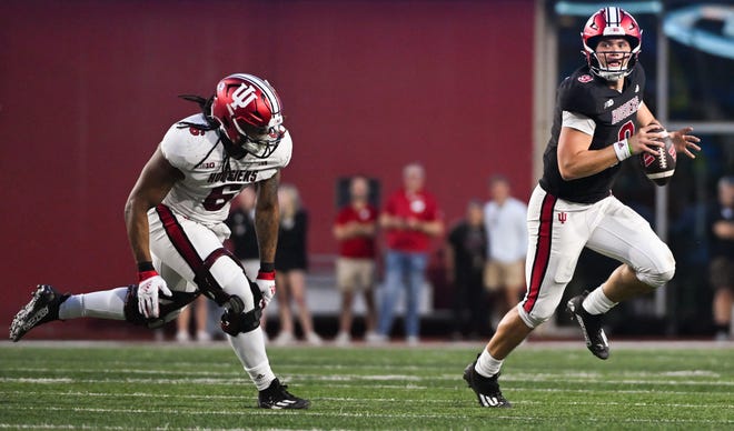 Indiana Hoosiers defensive lineman Mikail Kamara (6) forces Indiana Hoosiers quarterback Kurtis Rourke (9) out of the pocket during the Indiana football spring game at Memorial Stadium on Thursday, April 18, 2024.