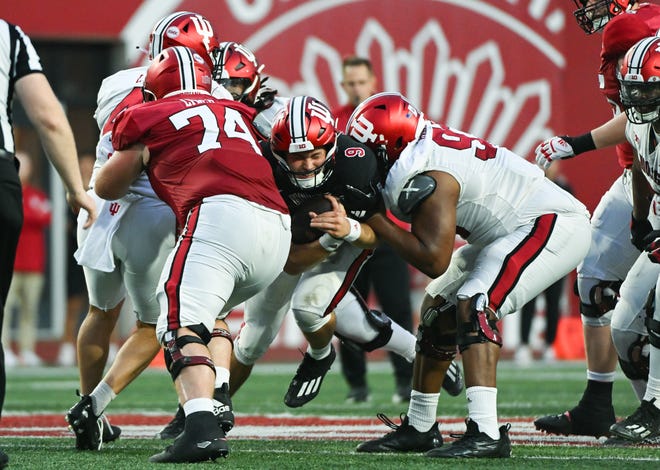 Indiana Hoosiers defensive lineman Robby Harrison (93) hits Indiana Hoosiers quarterback Kurtis Rourke (9) as he runs the ball during the Indiana football spring game at Memorial Stadium on Thursday, April 18, 2024.