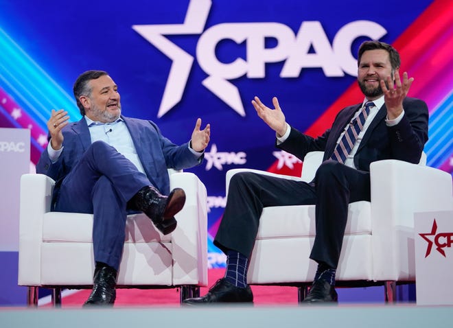 Senators J.D. Vance, right, (R-OH) and Ted Cruz (R-TX), left, speak on stage during the Conservative Political Action Conference, CPAC 2023, at the Gaylord National Resort & Convention Center on March 2, 2023