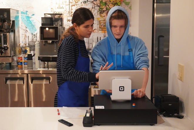 Allie Dodds and Wyatt Caves work at Scholar Sips, a new coffee shop at Bloomington High School South that opened in April.