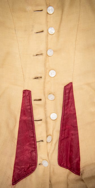 Ida Kenney's 1897 graduation dress features 12 bone buttons up the back from the waist to the neck. It is part of Indiana University's Elizabeth Sage Historic Costume Collection.