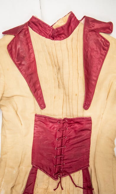 Lori Frye and Kelly Richardson would like to get this 1897 graduation dress worn by Ida Kenney out of the box and displayed on a mannequin. Here the collar is placed where the researchers assume it would have been, one of several parts of the dress that require restoration.