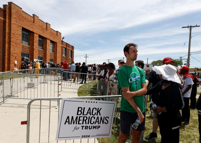 People wait outside before a roundtable discussion with former President Donald Trump inside the 180 Church in Detroit on Saturday, June 15, 2024.