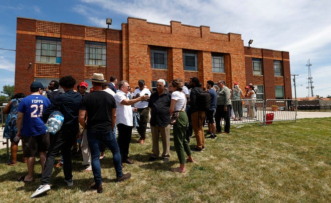 People wait outside before a roundtable discussion with former President Donald Trump inside the 180 Church in Detroit on Saturday, June 15, 2024.