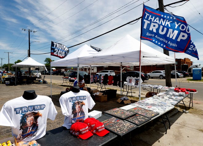 Various flags, hats and other items are for sale at tents a block away from the 180 Church before a roundtable discussion with former President Donald Trump inside the 180 Church in Detroit on Saturday, June 15, 2024.