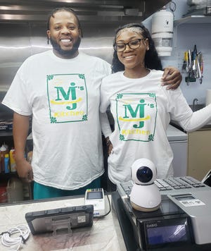 Robert Miles and Ci Jones stand behind the counter at MJs Kitchen, located inside the Shell gas station at the corner of Henderson Street and Winslow Road in Bloomington on June 24, 2024.