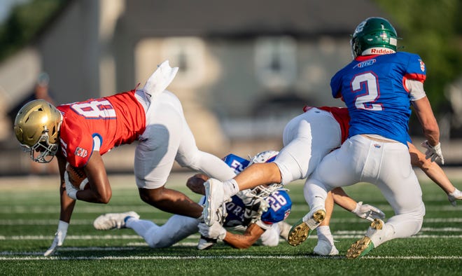 Indiana All-Star South Keith Long (81) is tackled by Indiana All-Star North Reis Beard (26) during the Indiana Football Coaches All-Star game, Friday, July 12, 2024, at Decatur Central High School in Indianapolis.