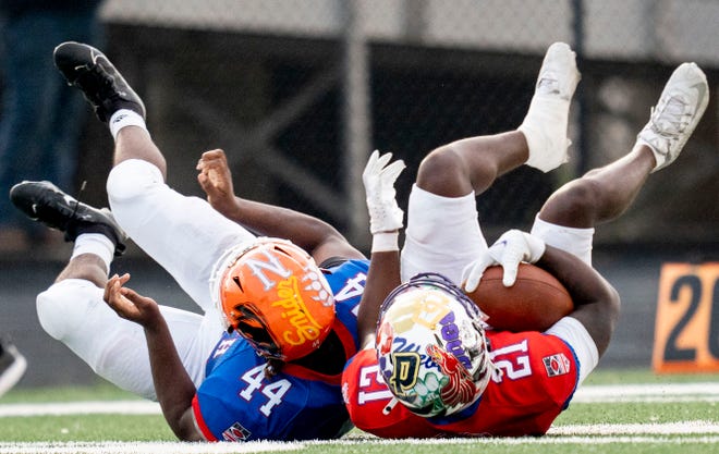 Indiana All-Star North Julante Hinton (44), left, and Indiana All-Star South Garrett Sherrell (21) dive for the ball during the Indiana Football Coaches All-Star game, Friday, July 12, 2024, at Decatur Central High School in Indianapolis.