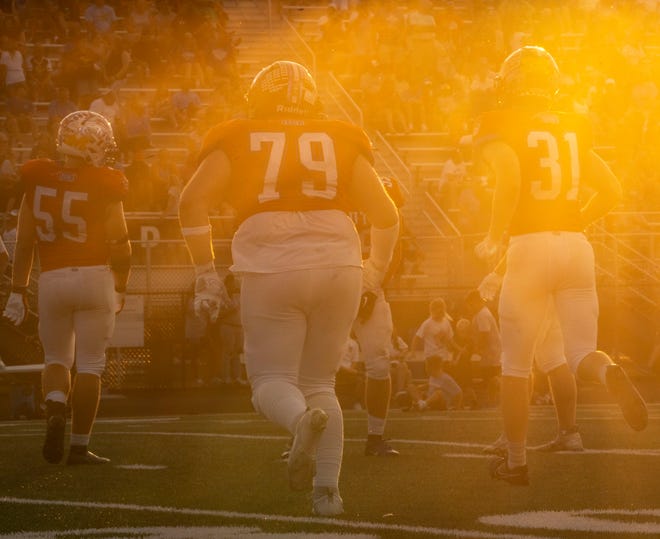 From left, Indiana All-Star South players Jack Seyferth (55), Luke Revell (79) and Carter Harris (31) run drills at the half during the Indiana Football Coaches All-Star game, Friday, July 12, 2024, at Decatur Central High School in Indianapolis.