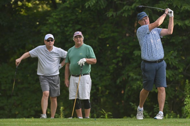 Charles Combs hits a tee shot as Jim Alexander (left) and Tim Gillespie look on during the semi-finals in the Senior Championship division in the City Golf Tournament at Cascades Golf Course on Saturday, July 13, 2024.