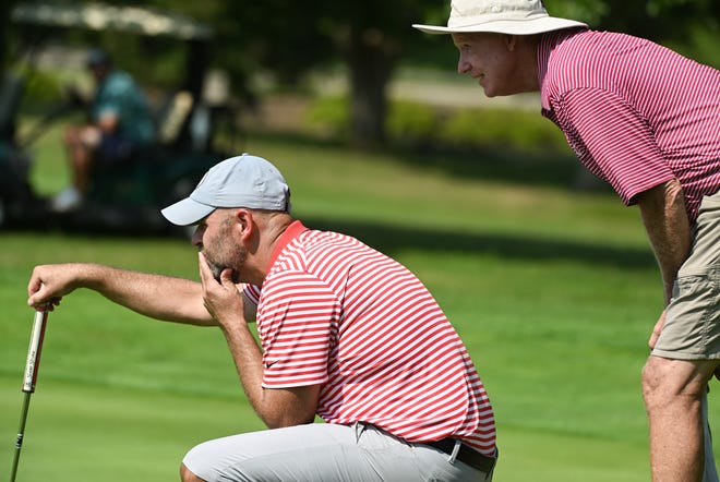 Chris Williams and caddie Bob Hasty look over a putt during the finals in the Men’s Championship division of the City Golf Tournament at Cascades Golf Course on Sunday, July 14, 2024.