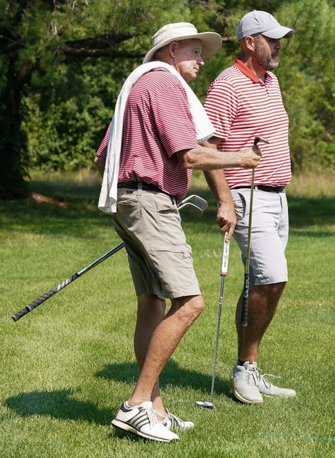 Caddie Bob Hasty (left) and Chris Williams discuss a shot during the finals in the Men’s Championship division of the City Golf Tournament at Cascades Golf Course on Sunday, July 14, 2024.