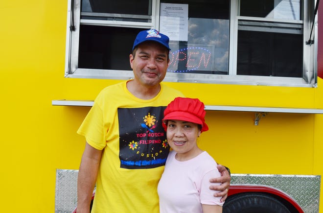 Jeff and Maria Milliken stand in front of their Top Notch Filipino Fusion food truck on July 12, 2024. The couple recently opened the food truck, parked in the Pomp's Tire Service parking lot.