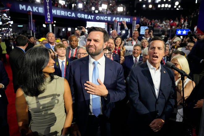 Sen. J.D. Vance, R-Ohio, and his wife, Usha Chilukuri Vance, left, attend the first day of the Republican National Convention in Milwaukee on July 15, 2024.