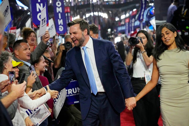 Sen. J.D. Vance (Ohio) celebrates with crowds on the floor as he introduced with his wife Usha Chilukuri Vance during the first day of the Republican National Convention. The RNC kicked off the first day of the convention with the roll call vote of the states.