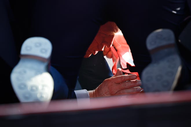 Secret Service tend to Republican presidential candidate former President Donald Trump onstage after he was grazed by a bullet at a rally on July 13, 2024, in Butler, Pennsylvania. Butler County District Attorney Richard Goldinger said the shooter is dead after grazing former President Trump with a bullet, killing one audience member and wounding another in the shooting.