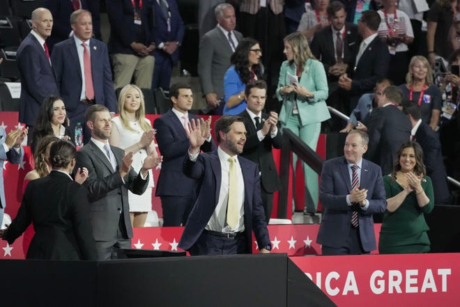 Vice Presidential nominee JD Vance waves from the family box during the second day of the Republican National Convention at the Fiserv Forum. The second day of the RNC focused on crime and border policies.