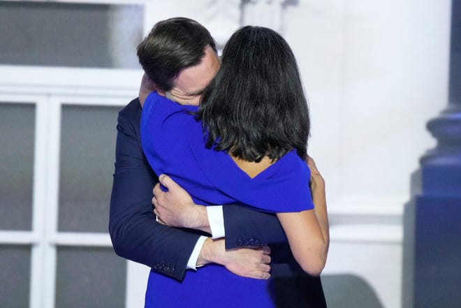 Vice presidential nominee JD Vance hugs his wife Usha Chilukuri Vance, during the third day of the Republican National Convention at Fiserv Forum. The third day of the RNC focused on foreign policy and threats.