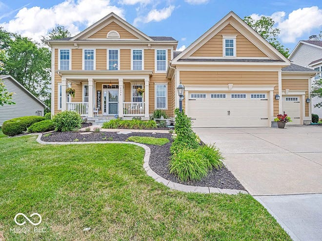 This home in Avon has tons of space inside and a backyard oasis outside with a swim spa and wooded backdrop.