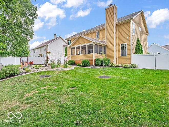 This home in Avon has tons of space inside and a backyard oasis outside with a swim spa and wooded backdrop.