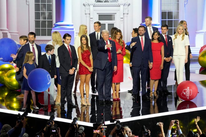 Donald Trump and his family along with JD Vance and his wife Usha Chilukuri Vance stand on stage as balloons drop at the the final day of the Republican National Convention at the Fiserv Forum. The final day of the RNC featured a keynote address by Republican presidential nominee Donald Trump.