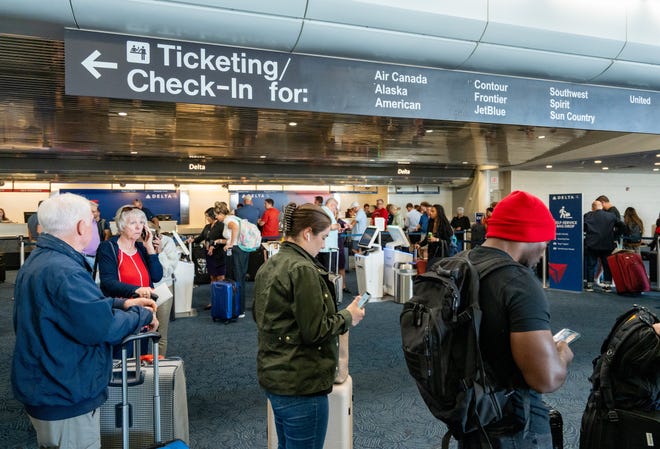 Long line forms at Delta Air Lines ticketing at Milwaukee Mitchell International Airport on Friday July 19, 2024 in Milwaukee, Wis. Flights are delayed and canceled due to a global tech outage, with RNC guests and security milling about in the main terminal.