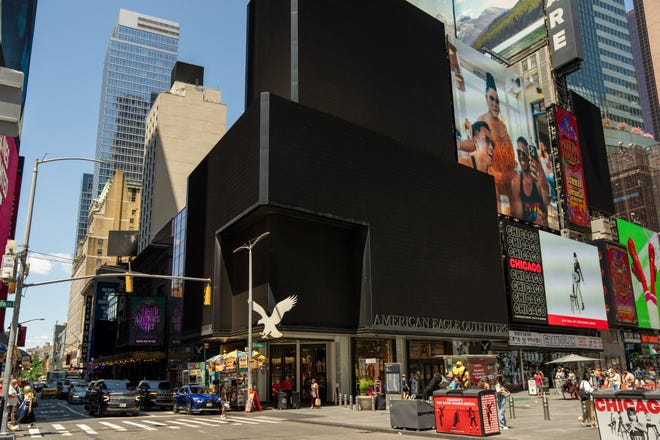 People stand near the blacked-out digital billboards at Times Square following a global IT outage, in New York City, U.S. July 19, 2024. REUTERS/David 'Dee' Delgado