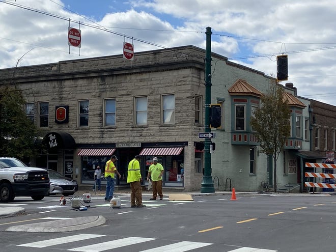 Construction and paint work for the dedicated bike lane is seen at the Seventh and Walnut street intersection.